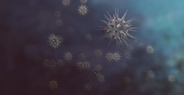 Illustration of multiple viruses against a blue background.